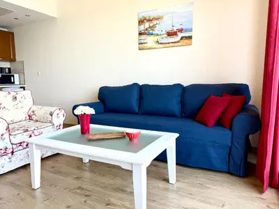 a living room with a blue couch and a coffee table at Cosher - Gardenia Palace Apt 10 Free Parking in Pomorie