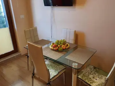 a glass table with a bowl of fruit on it at Garden of Eden - Panorama C2 in Sveti Vlas
