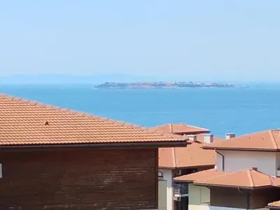 a group of houses with the ocean in the background at Garden of Eden - Panorama C2 in Sveti Vlas