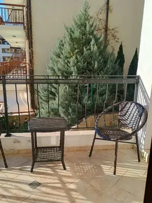 two chairs sitting on a balcony with a christmas tree at Garden of Eden - Panorama C2 in Sveti Vlas