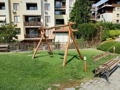a swing set in a park with a bench at Garden of Eden - Panorama C2 in Sveti Vlas