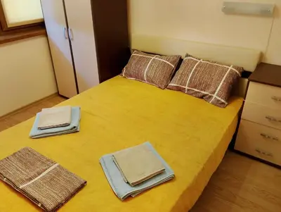 a bedroom with a bed with towels on it at Garden of Eden - Panorama C2 in Sveti Vlas