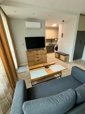 a living room with a couch and a tv at Work and Relax Studio in Green Life Beach Resort in Sozopol