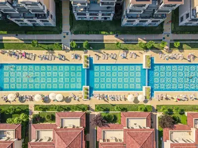 an overhead view of a swimming pool with people on the beach at Work and Relax Studio in Green Life Beach Resort in Sozopol