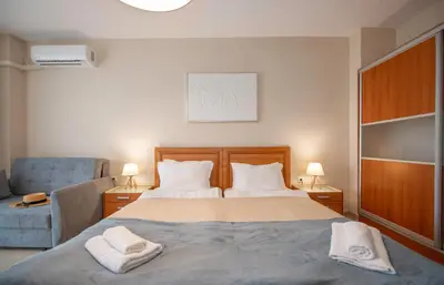 a bedroom with a bed with two towels on it at Stylish Holiday Apartments in Karolina in Sunny Beach