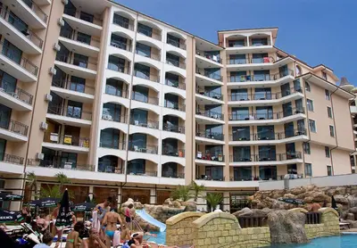 a large building with a pool and people in front of it at Stylish Holiday Apartments in Karolina in Sunny Beach