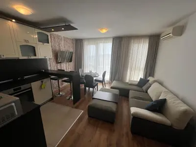 a living room with a couch and a dining room at Нощувки Град Бяла Terrazza sul mare in Byala