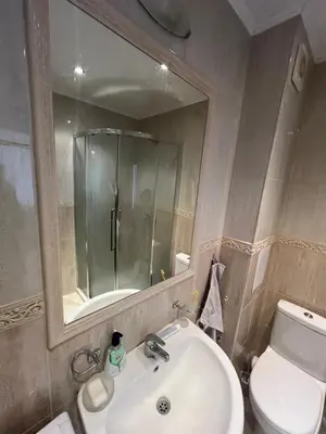 a bathroom with a sink and a toilet and a mirror at Нощувки Град Бяла Terrazza sul mare in Byala