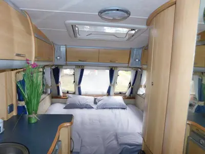 a bed in the back of a van with a table at The magical place in Chernomorets