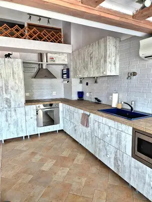 a kitchen with white cabinets and a sink at Blue Vista Apart in Burgas City
