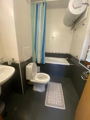 a bathroom with a toilet and a sink and a bath tub at Lavish, Poolside 2 Bed Apt at Garden of Eden in Sveti Vlas
