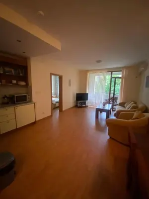 an empty living room with a couch and a table at Lavish, Poolside 2 Bed Apt at Garden of Eden in Sveti Vlas