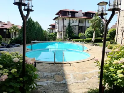 a large swimming pool in a yard with a building at Етъра - 2 Rey&Mar Свети Влас in Sveti Vlas