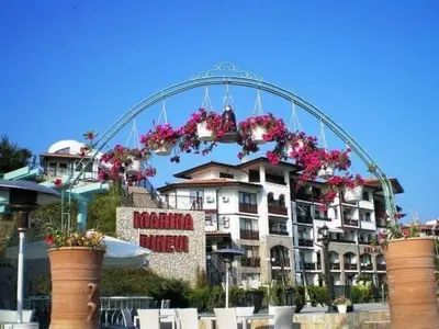 a large building with flowers in front of it at Етъра - 2 Rey&Mar Свети Влас in Sveti Vlas