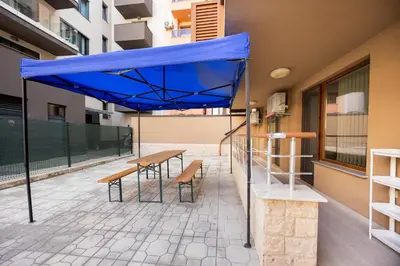 a blue umbrella over a table and chairs on a patio at Marea in Pomorie