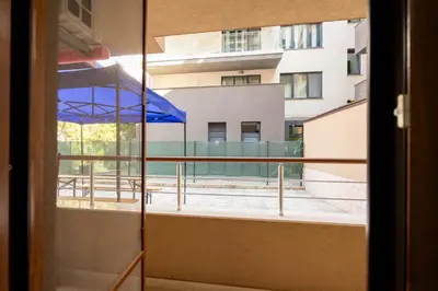 a view of a balcony with a blue umbrella at Marea in Pomorie