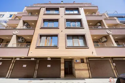 a tall building with garages in front of it at Marea in Pomorie