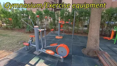 a group of exercise equipment sitting next to a tree at Excelsior Prince ApartHotel in Sunny Beach