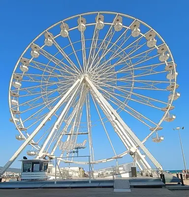 a large ferris wheel in front of a blue sky at Excelsior Prince ApartHotel in Sunny Beach