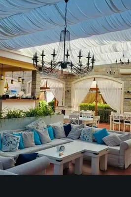 a living room with a large couch and a chandelier at Cascadas one-bedroom apartment with a living room in Sunny Beach