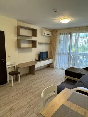 a living room with a couch and a desk with a television at Cascadas one-bedroom apartment with a living room in Sunny Beach