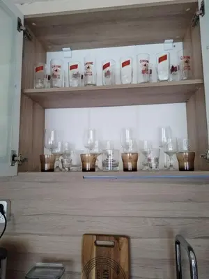 a counter with a bunch of glasses on it at Comfort apartment near the beach in Varna City