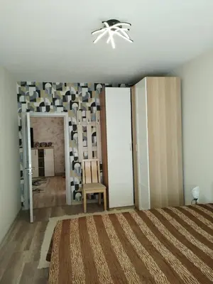 a bedroom with a bed and a chandelier at Comfort apartment near the beach in Varna City