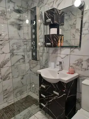 a bathroom with a sink and a toilet at Comfort apartment near the beach in Varna City
