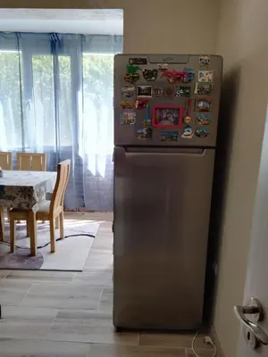 a refrigerator in a kitchen with magnets on it at Comfort apartment near the beach in Varna City
