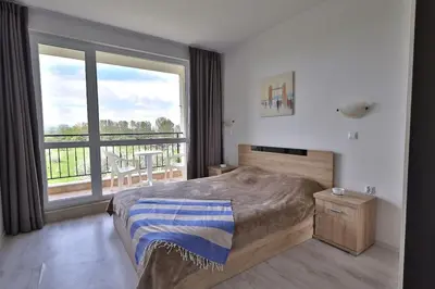 a bedroom with a bed and a large window at Apartament Casa del Sol no 115 in Sunny Beach