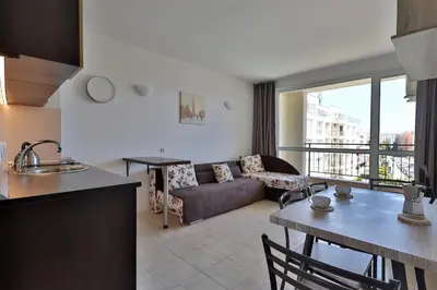a kitchen and living room with a couch and a table at Apartament Casa del Sol no 115 in Sunny Beach