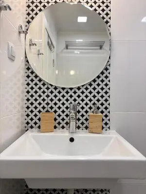 a white sink in a bathroom with a mirror at Cozy Corner in Varna - Free Parking in Varna City