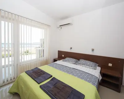 a bedroom with a bed and a large window at 