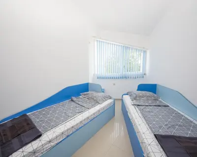 two beds in a room with a window at 