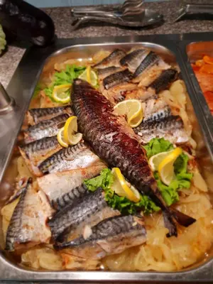 a tray of food with fish on top of pasta at Grenada Complex All Inclusive in Sunny Beach