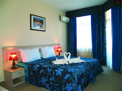 a bedroom with a bed with two rabbits on it at Grenada Complex All Inclusive in Sunny Beach