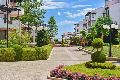 a street in a town with flowers and buildings at Oasis Premium Studio in Lozenets