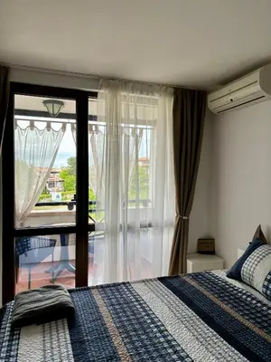 a bedroom with a bed and a large window at Oasis Premium Studio in Lozenets