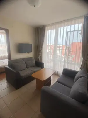 a living room with a couch and a table at 2 Bed Suite with Pool Views in Sunny Beach