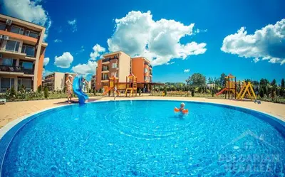 a large swimming pool with a child in the water at 2 Bed Suite with Pool Views in Sunny Beach
