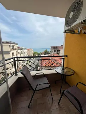 a balcony with a table and chairs on a balcony at Апартамент Габи 1 in Burgas City