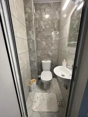 a bathroom with a toilet and a sink at Апартамент Габи 1 in Burgas City