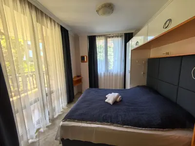 a bedroom with a bed with a stuffed animal on it at Stela Apartment in Santa Marina Holiday in Sozopol