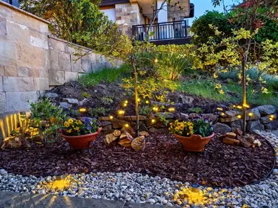 a garden with two flower pots with lights in it at Stela Apartment in Santa Marina Holiday in Sozopol