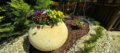 a large vase filled with flowers in a garden at Stela Apartment in Santa Marina Holiday in Sozopol