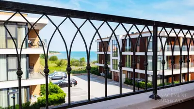 a balcony with a view of a street and buildings at Sea-breeze retreat Zerini in Burgas City