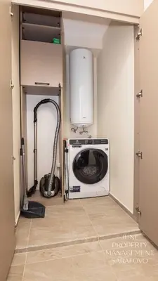a laundry room with a washer and dryer in a room at Sea-breeze retreat Zerini in Burgas City