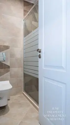 a bathroom with a shower and a glass door at Sea-breeze retreat Zerini in Burgas City