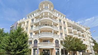 a large white building with balconies on it at Villa Roma Gs' Apartment in Nesebar