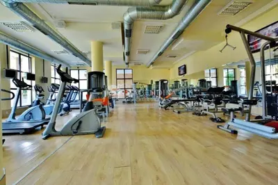 a gym with a bunch of treadmills and machines at Villa Roma Gs' Apartment in Nesebar